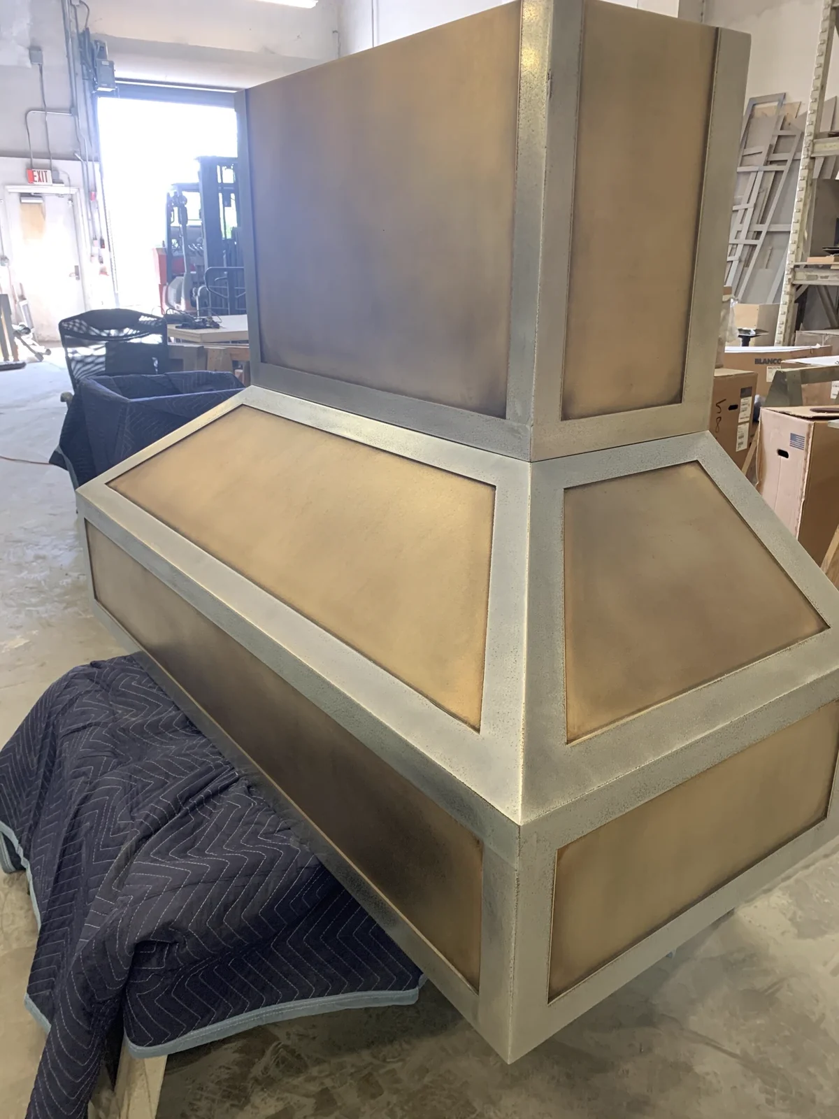 Custom cast pewter and brass range hood by La Bastille