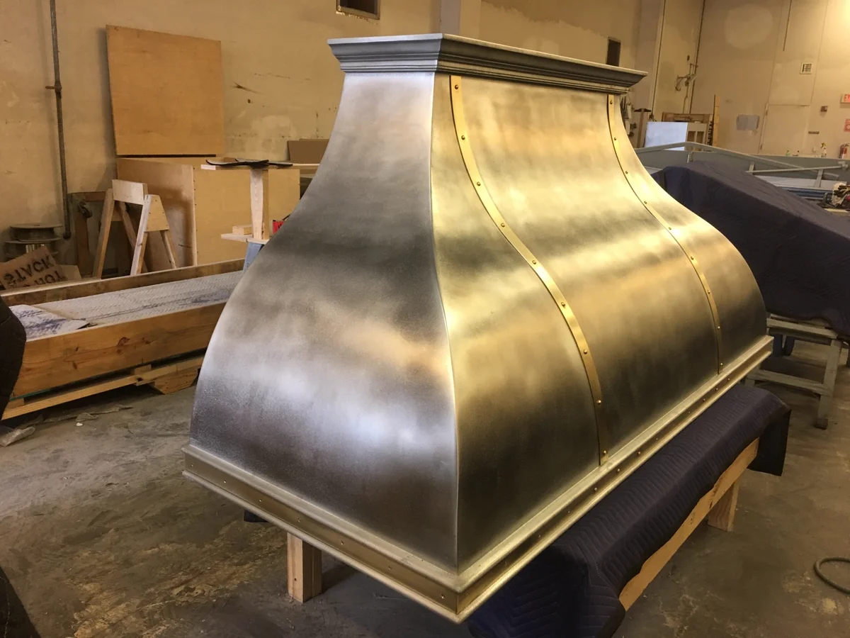 Custom cast zinc and brass range hood by La Bastille