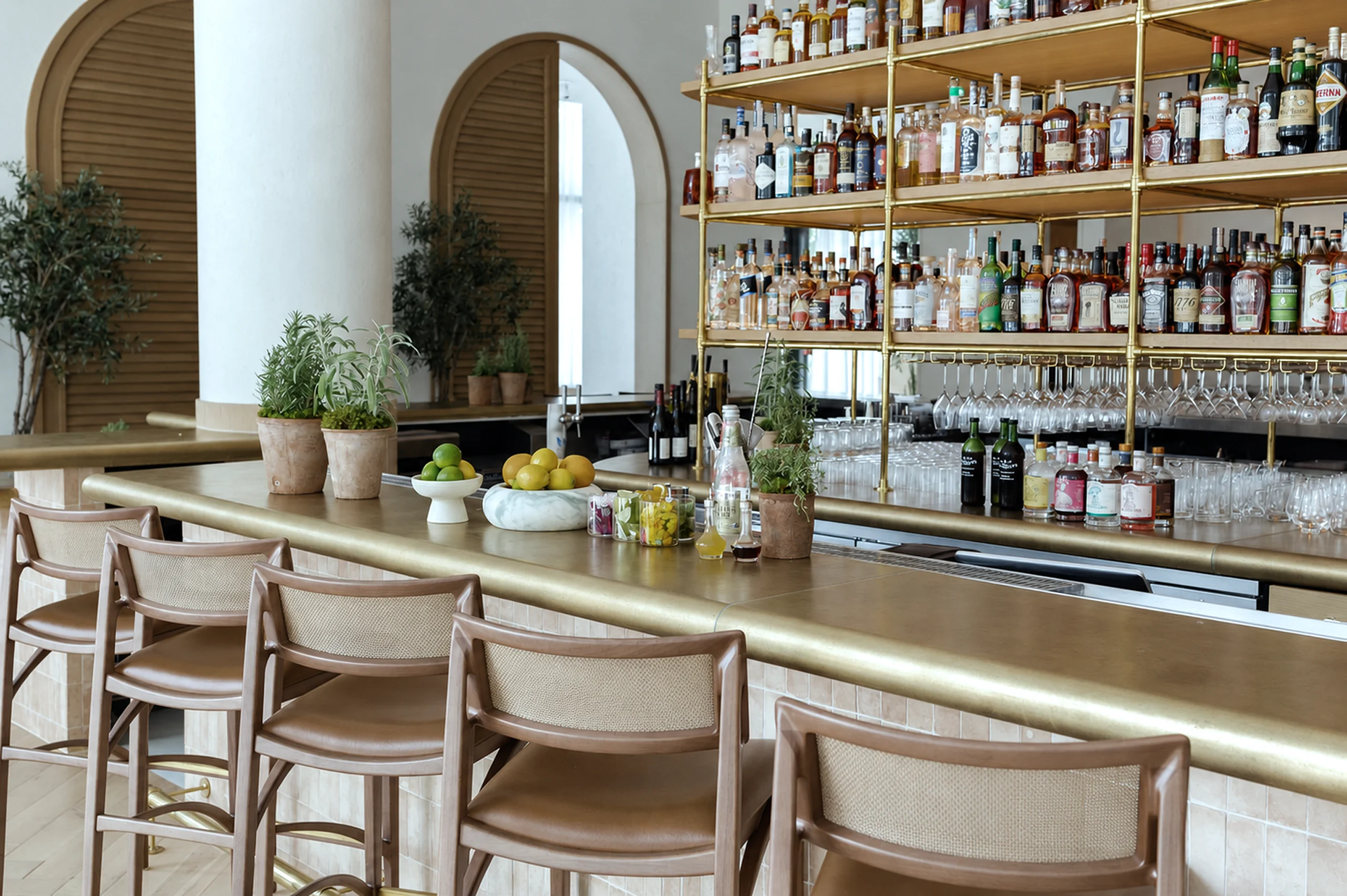 A brass bar top with cane-back stools in a restaurant bar